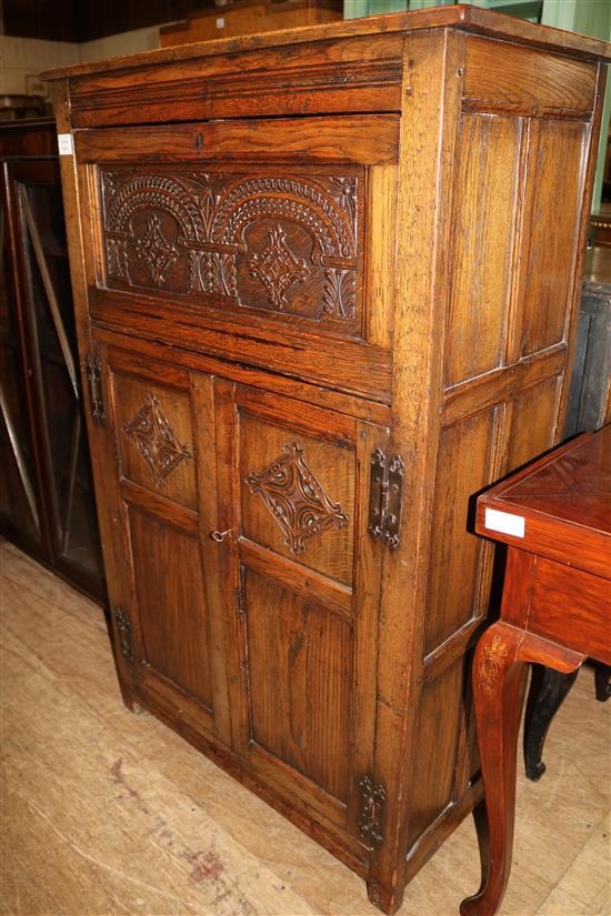 17th century style carved oak panelled cupboard(-)